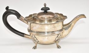 Edward VII hallmarked silver teapot with shaped edge and raised on four feet, Birmingham 1904, maker