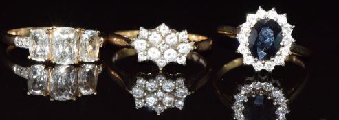 Three 9ct gold rings, one set with aquamarine and diamonds, one sapphire and paste and one cubic