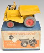 Dinky Supertoys diecast model Dumper Truck with yellow body, red hubs and beige driver, 562, in