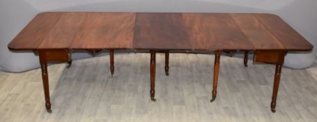 Regency 19thC Wilkinson patent type mahogany extending dining table with three extra leaves in the