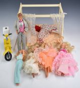 Six Sindy, Barbie and Ken dolls in various outfits together with accessories, scooter etc.