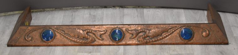 Arts & Crafts copper fire kerb with relief moulded decoration of winged serpents/dragons and