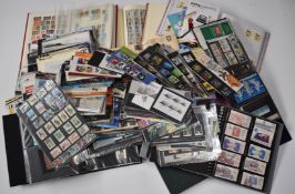 A large accumulation of GB mint postage stamps in albums, presentation packs etc along with first