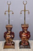 Two Chinese red ceramic lights, with brass finials, height 120cm