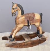 Carved wood rocking horse with leather fittings, length 86cm