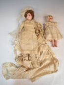 Two late 19th/ early 20thC wax dolls 'Lady Constance' with fixed brown eyes, brown hair, composite