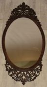 Fretwork and carved framed oval mirror, overall height  83cm