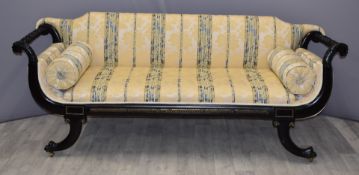 Regency or Empire 19thC sofa with scroll ends terminating in lion heads, the gilt metal mounted feet