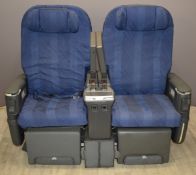 Pair of aeroplane seats with integral fold out screens, seat adjustments etc, width 136cm