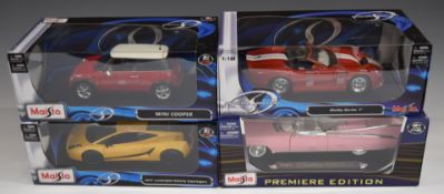 Four Maisto 1:18 scale diecast model cars comprising Mini Cooper, Shelby Series 1, 1959 Cadillac