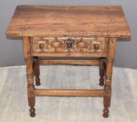 Antique possibly fruitwood side table with single drawer, raised on turned legs united by