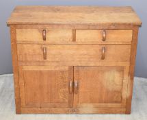 Roseman (Mouseman apprentice) adzed oak sideboard fitted three drawers over double cupboard doors,