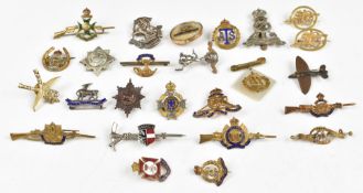 Twenty five assorted metal, metal and enamel badges including Royal Artillery, Queen Victoria's