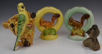 Two Burleigh Ware squirrel flower frogs, budgie wall pocket and a Poole pottery bird, tallest 20cm