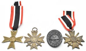 Three WW2 German Nazi Third Reich Cross of Merit medals together with a wound badge