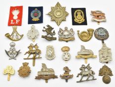 Approximately twenty British Army infantry badges including West Surrey Regiment, Manchester
