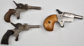 Three blank firing and replica pocket or muff pistols, the largest Derringer style12cm long.