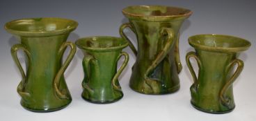 Farnham Art Pottery four graduated flared vases with wrythen handles