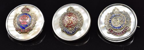 Three mother of pearl and enamel sweetheart brooches for the Royal Engineers, one stamped silver