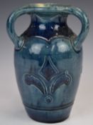 Farnham Art Pottery vase with three loop handles and fleur de lys style decoration, 15cm tall