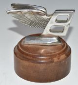 Bentley winged B car mascot, on turned wood base, height 9.5cm