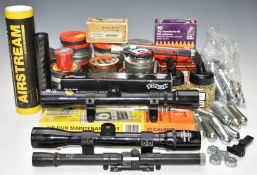 A collection of air rifle parts and accessories including three scopes, pellets, CO2 canisters,