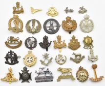 Approximately 28 British Commonwealth badges including 1st Punjab Regiment, King's African Rifles,