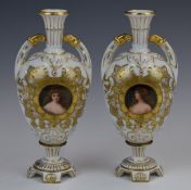 Pair of 19th/20thC porcelain twin handled pedestal vases with portrait cartouches and gilt/