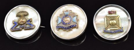 Three mother of pearl, enamel and silver rim sweetheart brooches for the Lancashire Fusiliers,