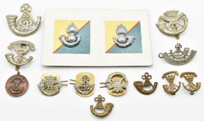 Fourteen British Army Light Infantry badges including Somerset Light Infantry and Cornwall Light