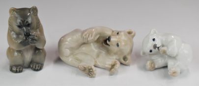 Three Royal Copenhagen models of bears comprising white rolling bear, brown bear eating and polar