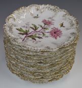 Eleven Limoges cabinet plates with relief moulded rims and decorated with flora and fauna,
