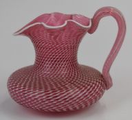 Venini Murano style latticinio cranberry and white glass jug with applied handle, 10cm tall.