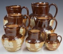 Group of seven Royal Doulton salt glazed harvest jugs