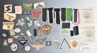 Small collection of replica German Nazi Third Reich cloth and metal badges, insignia etc