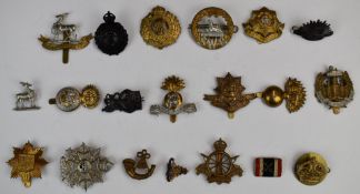Nineteen British Army metal badges including South Wales Borderers, Royal Dublin Fusilier, Border