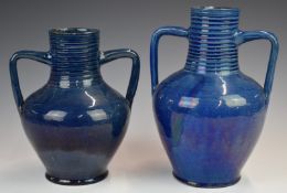 Two Farnham Art Pottery twin handled vases with ribbed decoration, 25cm and 22cm