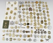 Approximately 100 anodised cap badges including Royal Army Catering Corps, Royal Army Medical Corps.