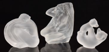 Three Sèvres frosted glass paperweights, two in the form of nude ladies the other of two bears,