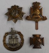British Army Devonshire Regiment cap badges with Queen's Crown, together with a Dorsetshire Regiment