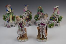 Four Derby / Chelsea style porcelain figures with applied floral decoration and gilt anchor marks,
