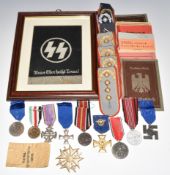 Ten replica German Nazi Third Reich medals together with replica documents, a replica framed Nazi