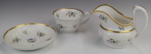 19thC relief moulded cup and saucer with jug