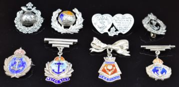 Eight Royal Navy / Royal Marines silver and enamelled sweetheart brooches including two hallmarked