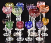 Sixteen flash overlaid cut glass hock glasses in various colours and designs, largest 21cm tall.