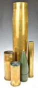 Four brass shells of various sizes including 105mm dated 1978, 40mm and a projectile, tallest 60cm
