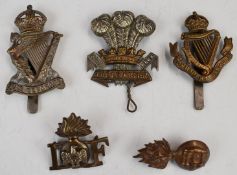 Five British Army badges comprising Leicester Regiment, Connaught Rangers, Royal Irish Fusiliers,