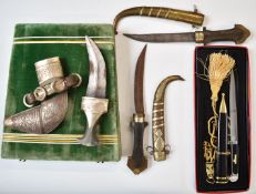 Three Middle Eastern daggers comprising a boxed Jambiya with 15.5cm blade and two further examples