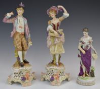 Pair of Volkstedt figures with grapes and jugs and a figurine with an owl at her feet, tallest 26cm