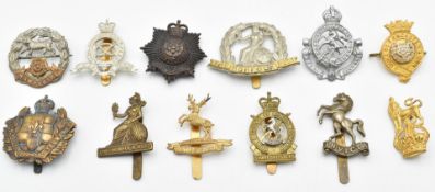 Twelve British Army badges including Royal Hampshire, The Norfolk Regiment, Duke of Lancaster's Own,